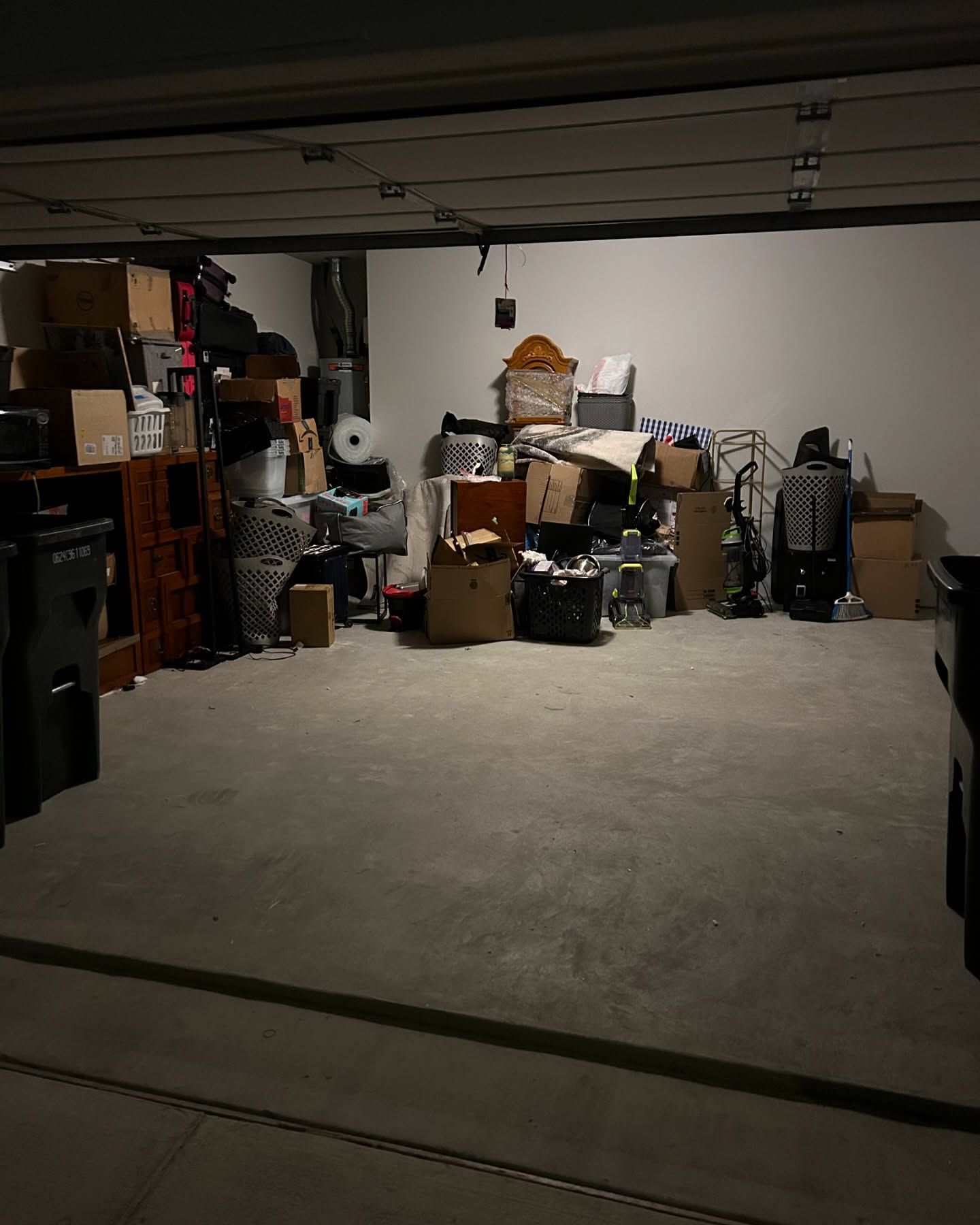A garage filled with lots of boxes and furniture.
