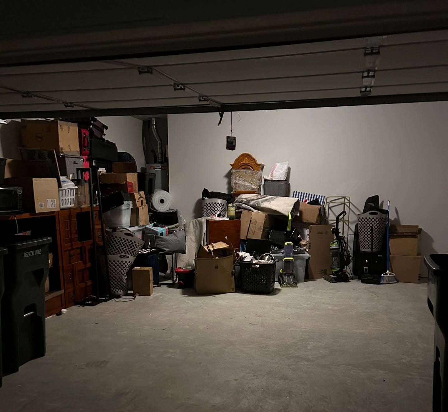 A garage filled with lots of boxes and furniture.