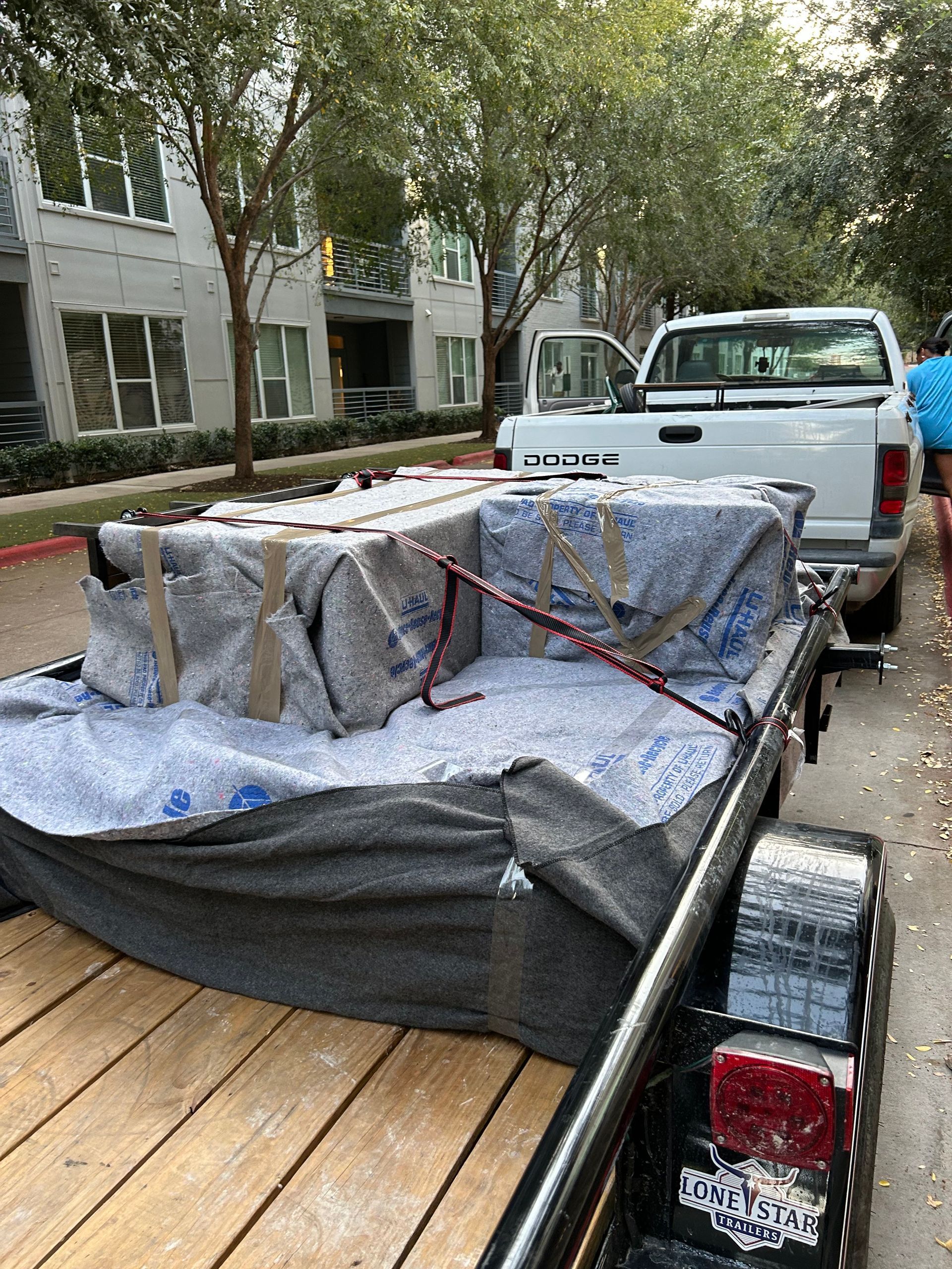 A couch is sitting on the back of a truck.