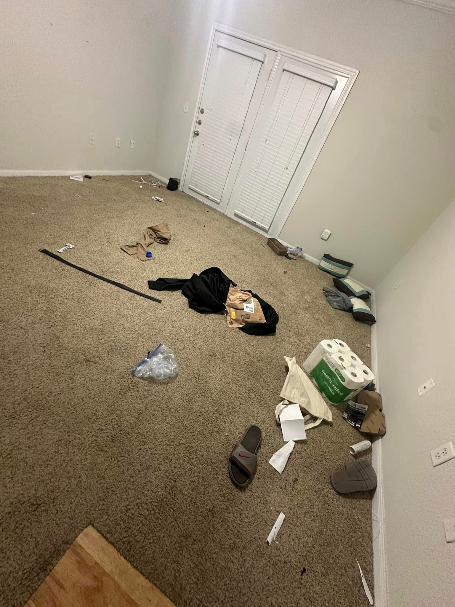 A room with a lot of trash on the floor.