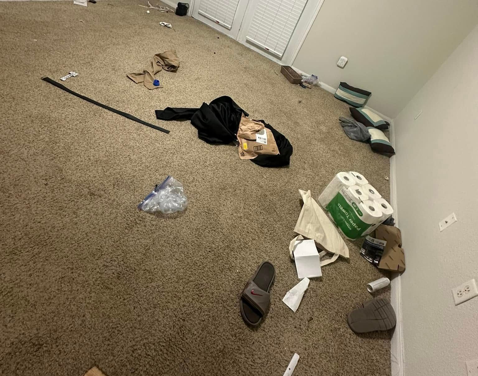 A room with a lot of trash on the floor.