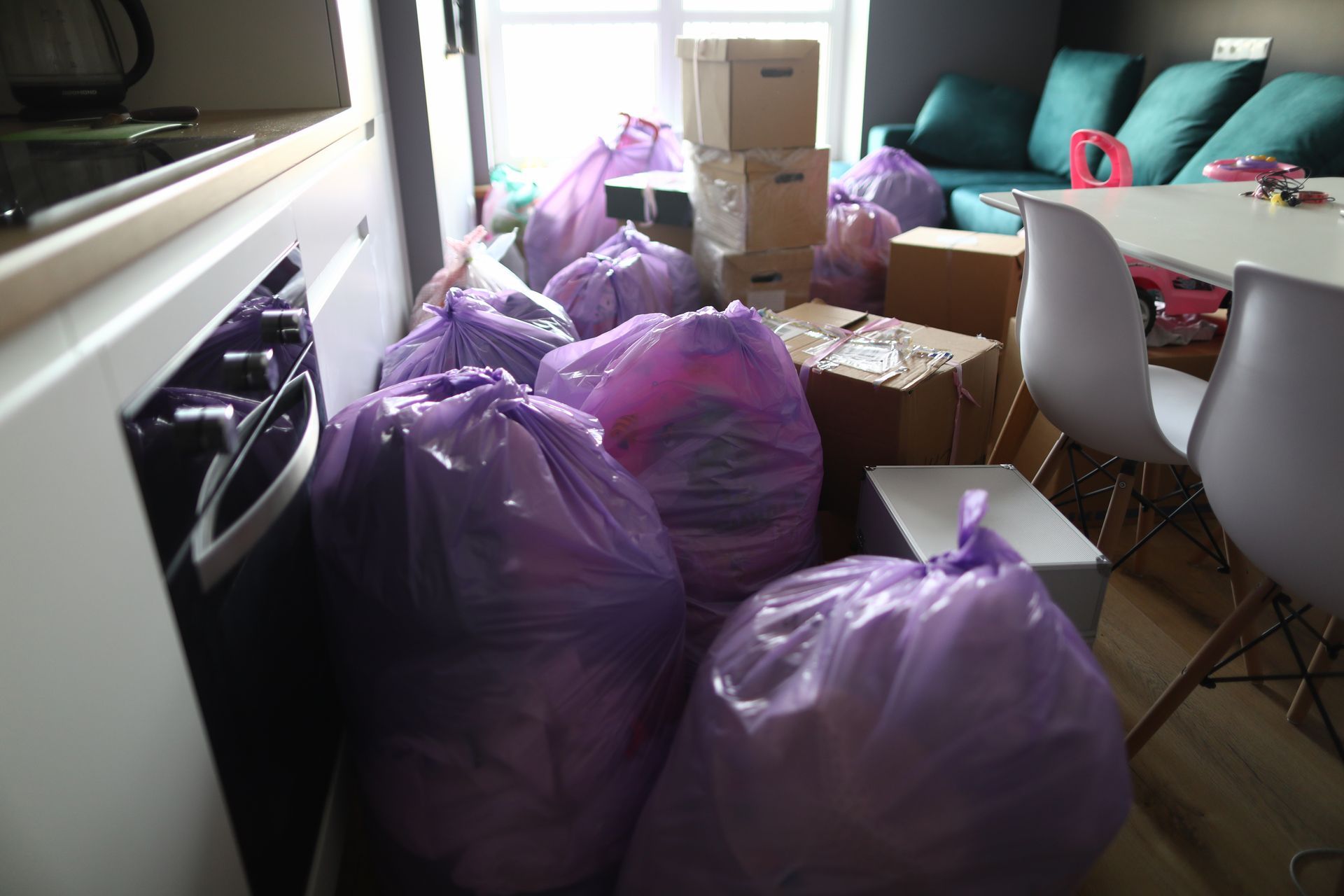 A living room filled with purple bags and boxes.