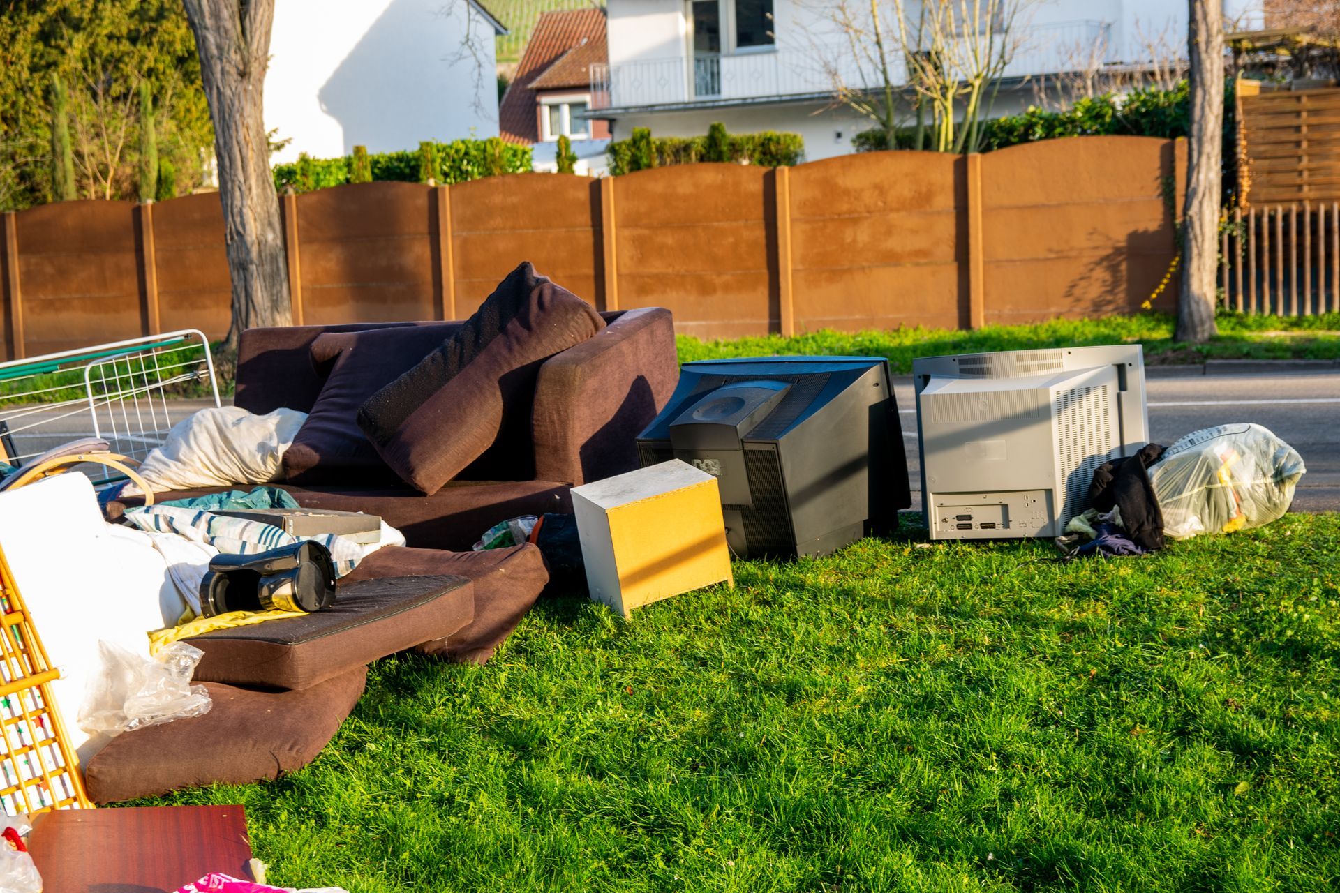 A pile of junk is sitting on top of a lush green lawn.