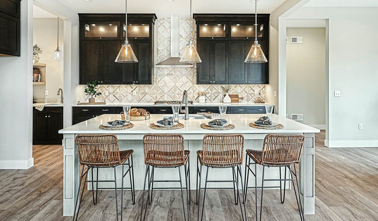 Brushed nickel pendant lights above  breakfast bar in new home by Landmark Homes