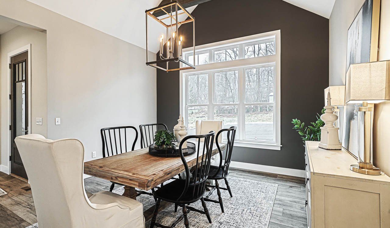 Dramatic brushed nickel lighting fixture in dining room of new home by Landmark Homes