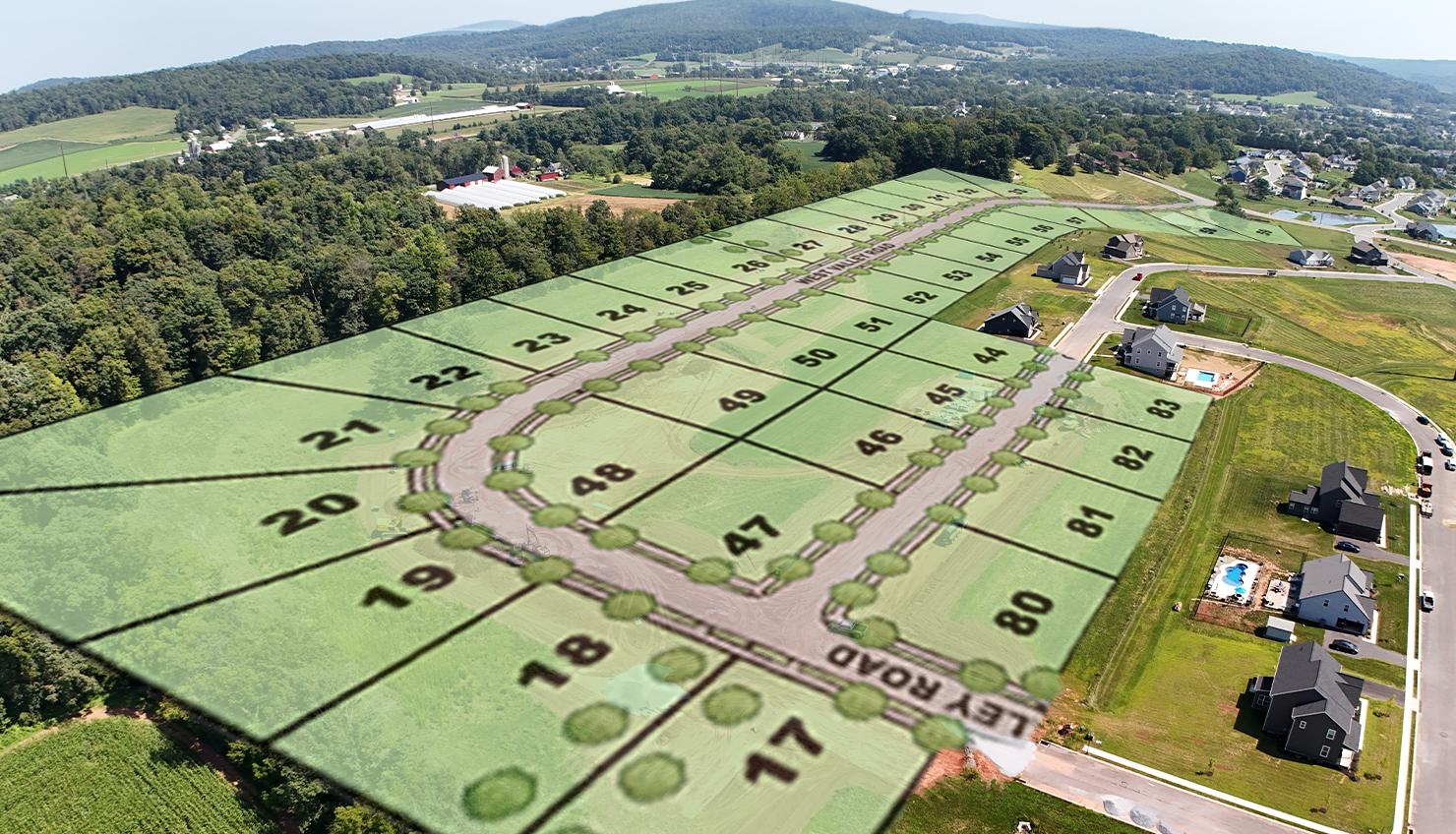 An aerial view of a residential neighborhood with lots of trees.