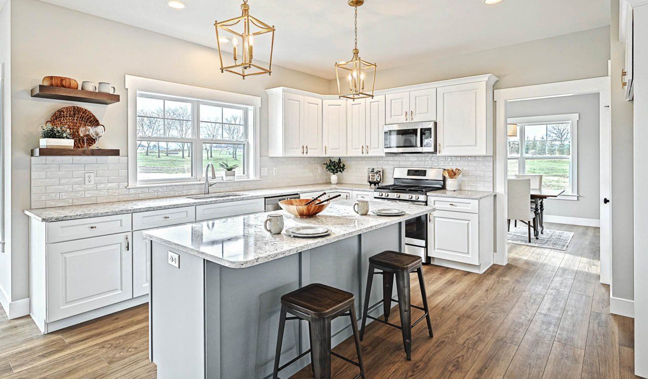 Brushed bronze lighting over breakfast bar in new home by Landmark Homes