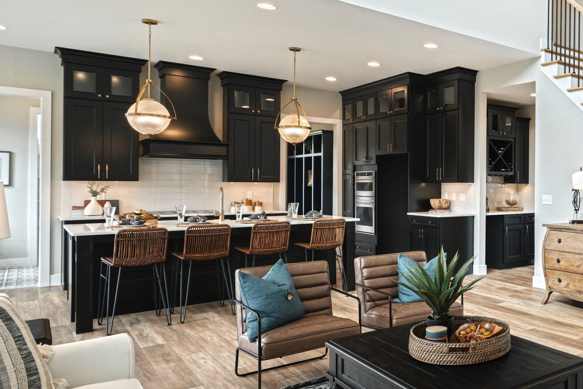 Brushed bronze orb lighting fixtures above breakfast bar in new home by Landmark Home