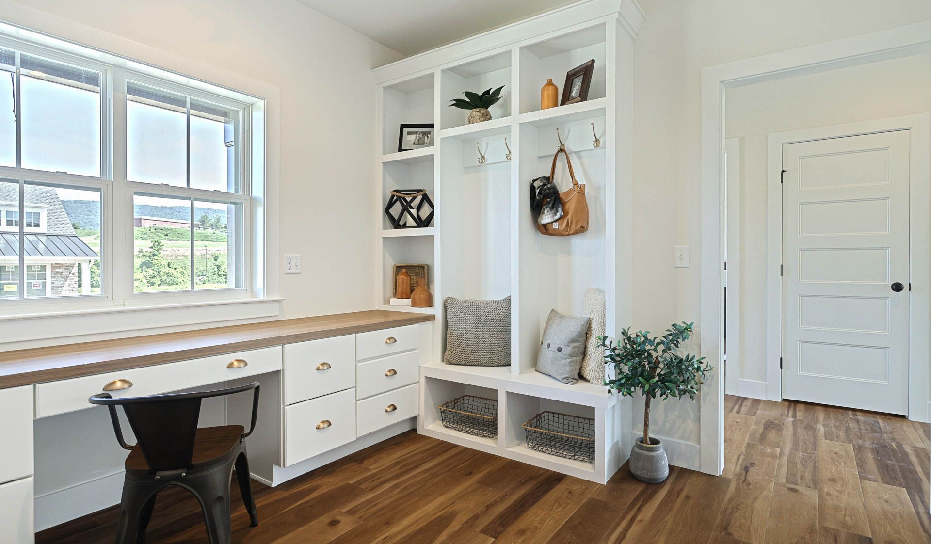 Home office for back to school and remote work featuring green wallpaper with built-in shelving