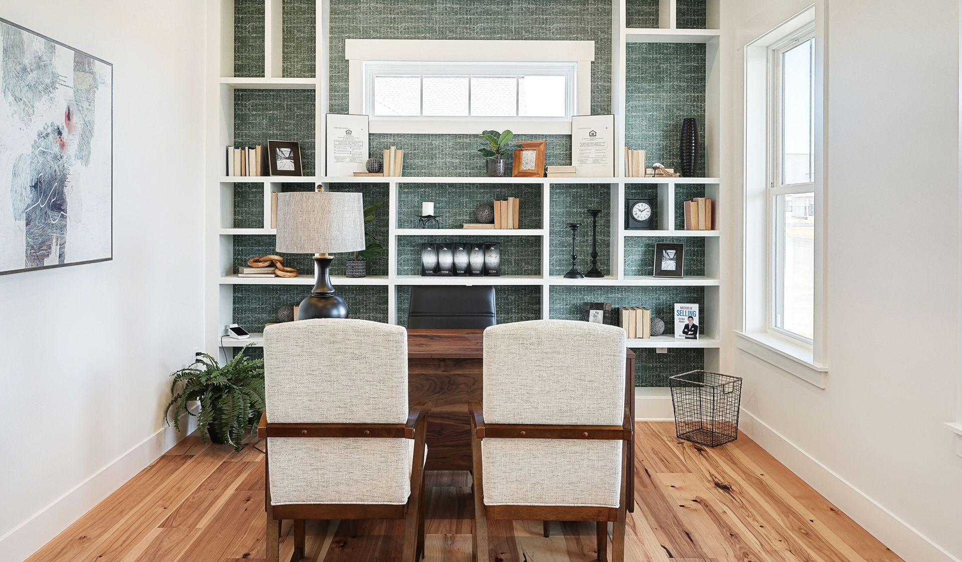 Home office for back to school and remote work featuring green wallpaper with built-in shelving