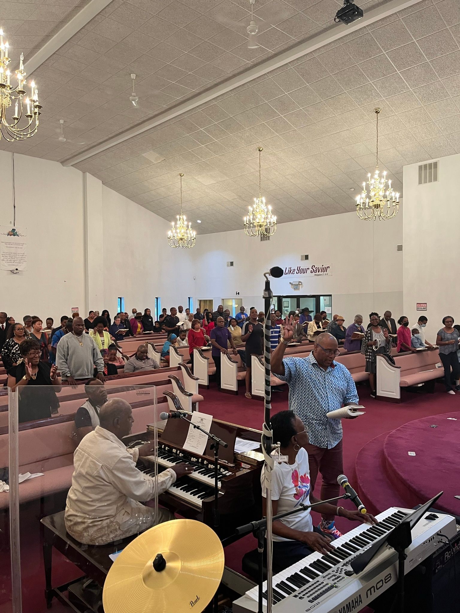 A group of people are playing keyboards in a church