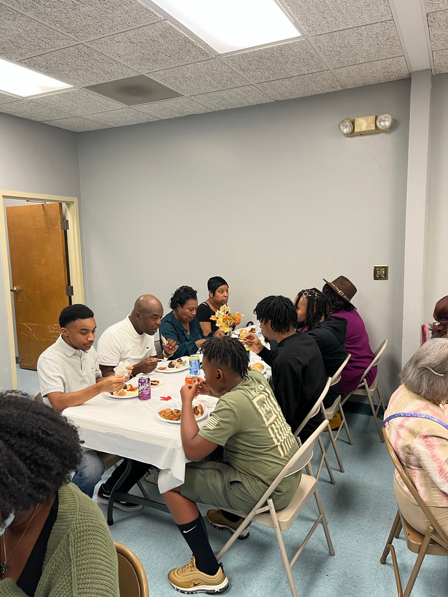 A group of people are sitting at a table eating food.