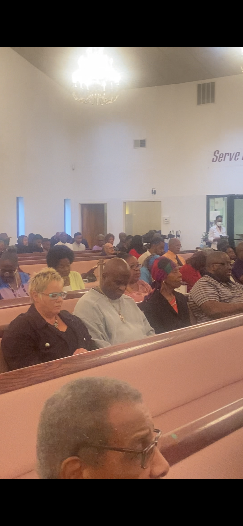 A large group of people are sitting in a church.