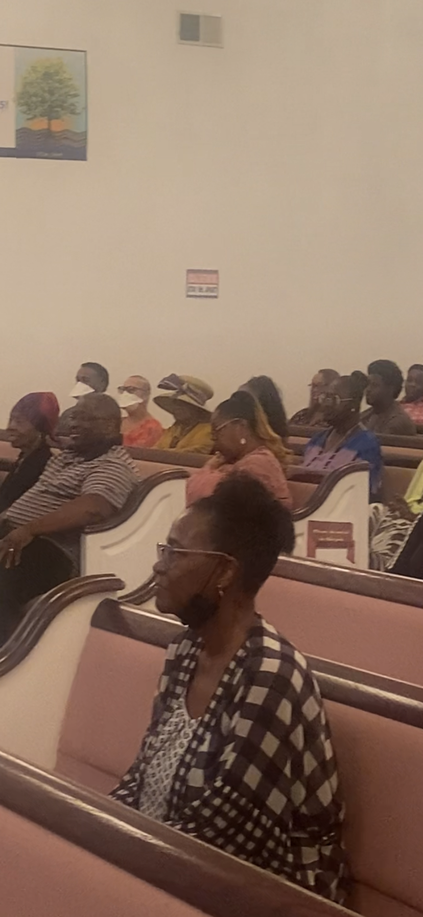 A group of people are sitting in a church.