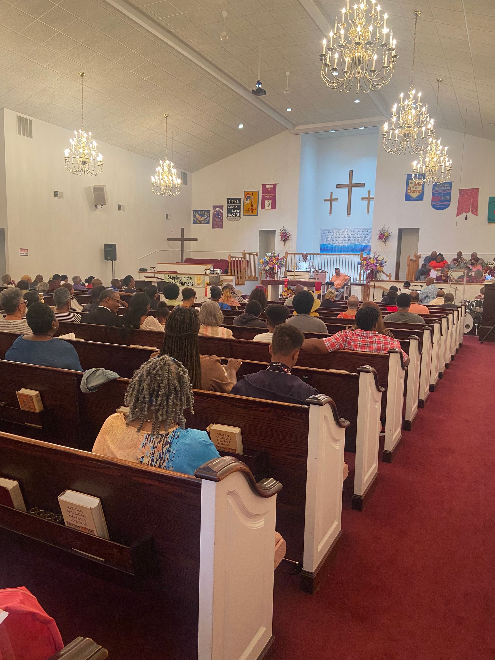 A large group of people are sitting in a church.