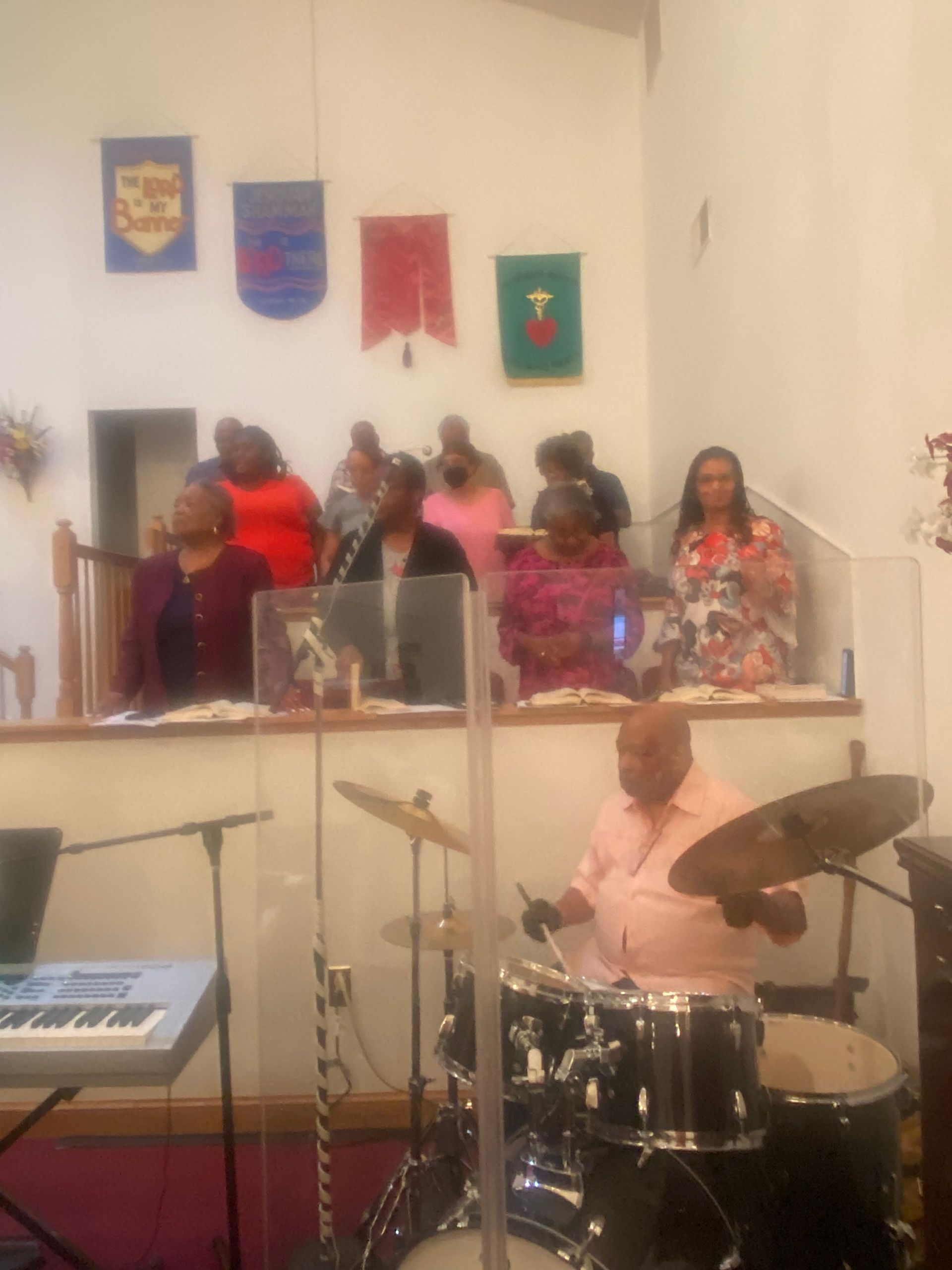 A man is playing drums in front of a crowd of people