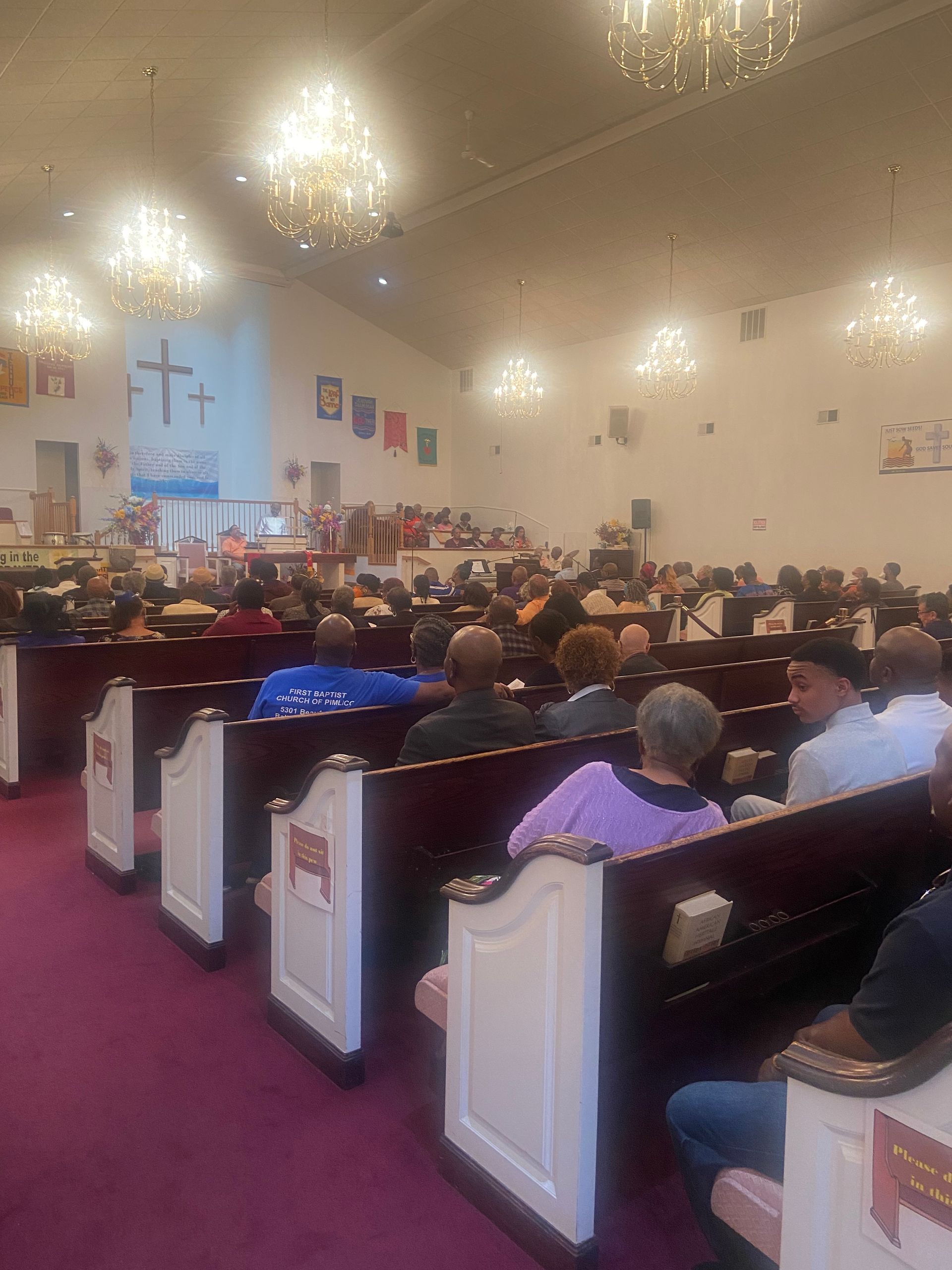 A large group of people are sitting in a church.
