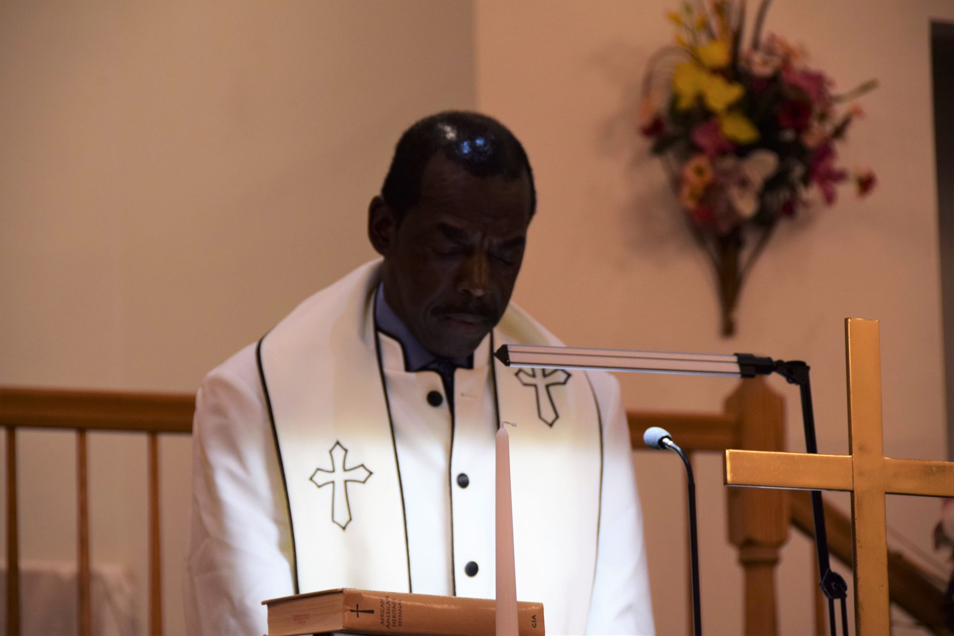 A man in a white robe with a cross on it