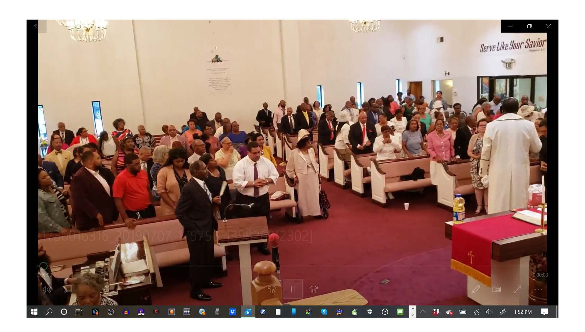 A large group of people are sitting in a church.