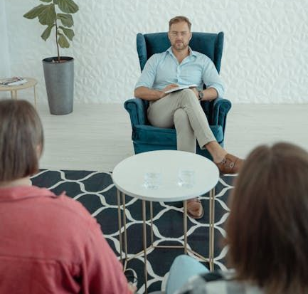 A man sitting coaching a couple