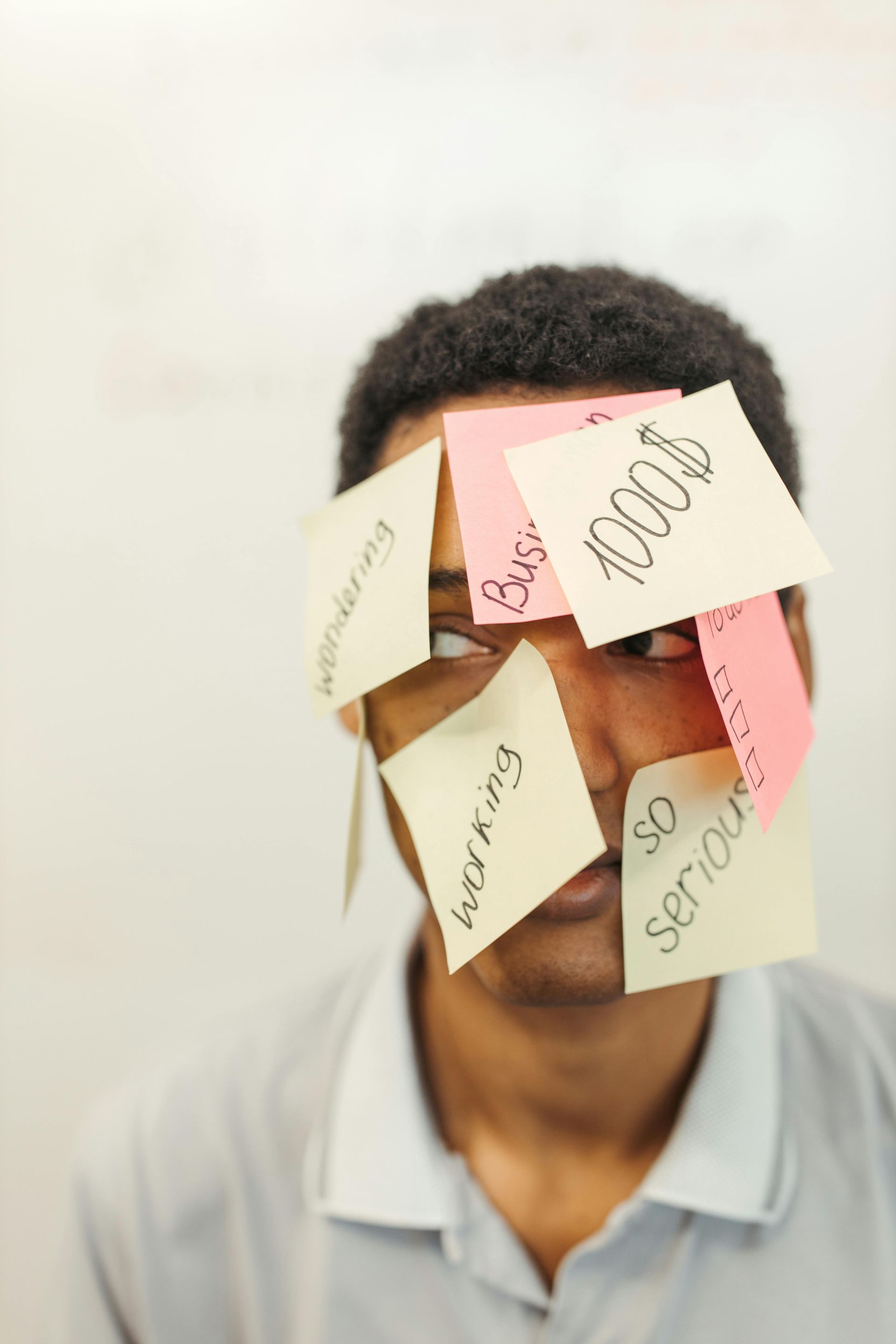 A man with Post-It notes all over his head.