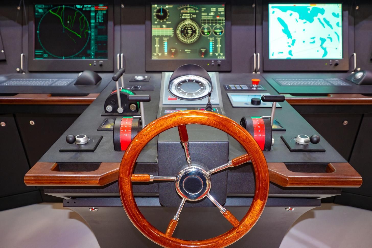 Ship's navigation control panel with a wooden helm, radar displays, and other controls.