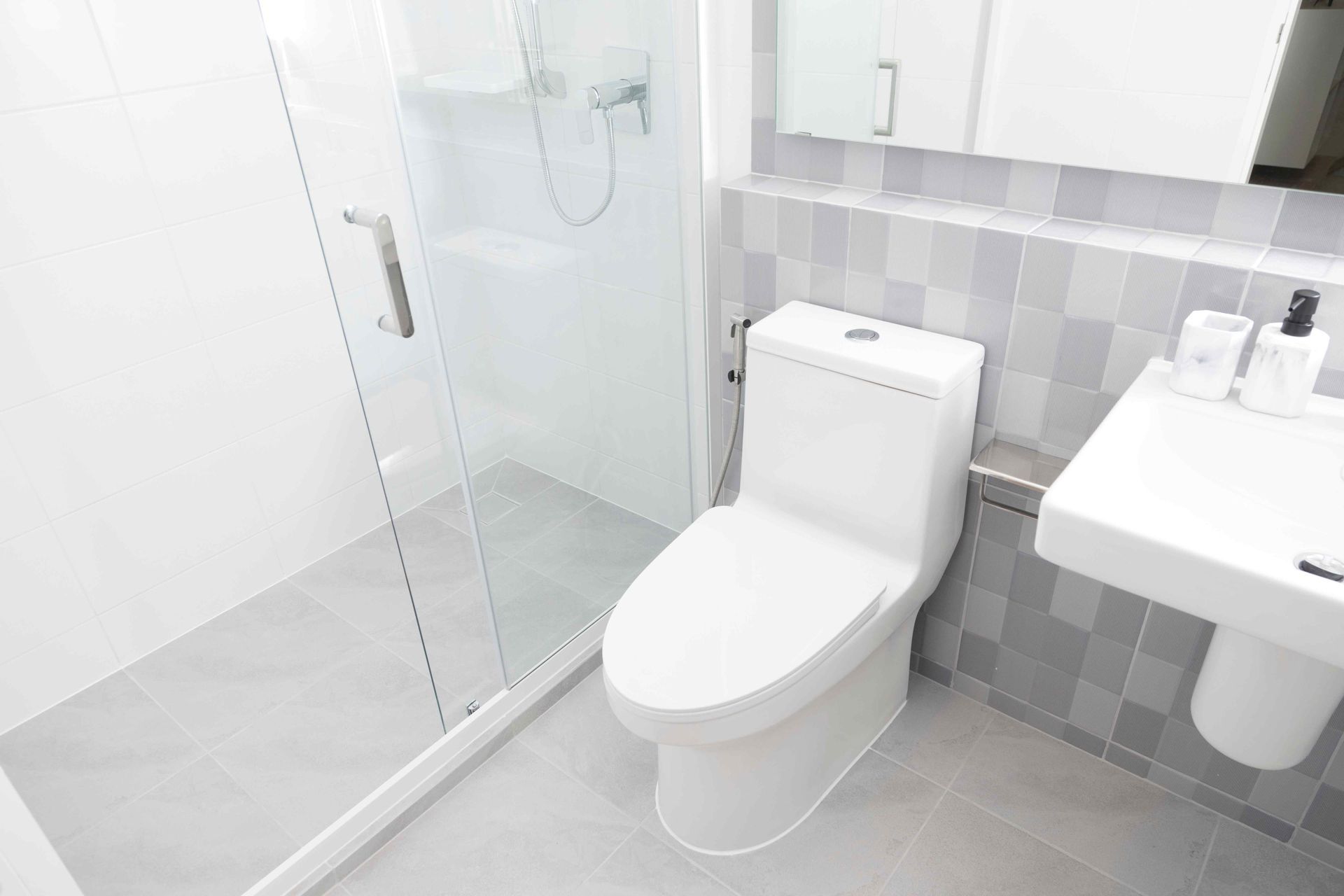 Handyman Maple Ridge: A bathroom with a toilet , sink and shower.