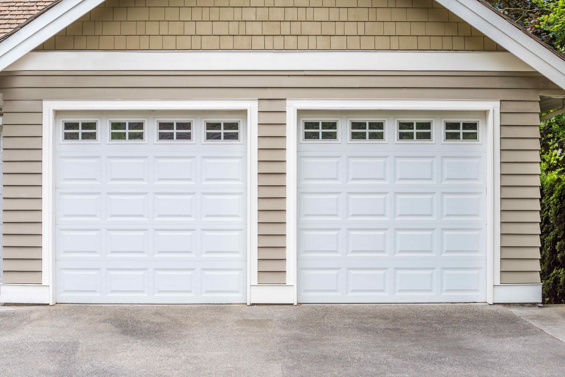 Handyman Maple Ridge: A double garage with two roll-up doors.