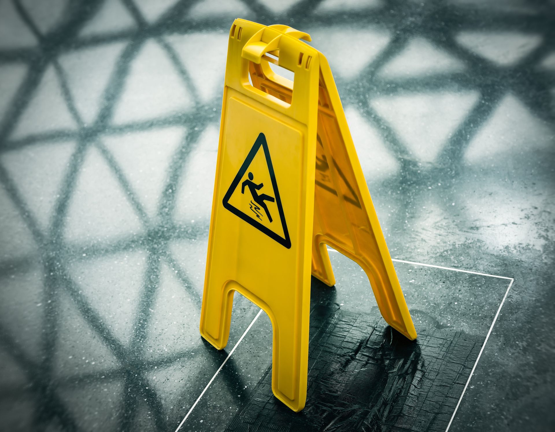 A yellow caution sign is sitting on a wet floor.