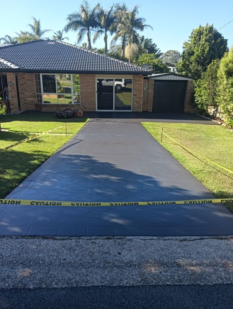 A Brick House With a Concrete Driveway in Front of It — A-Z Property Painting In Karuah, NSW