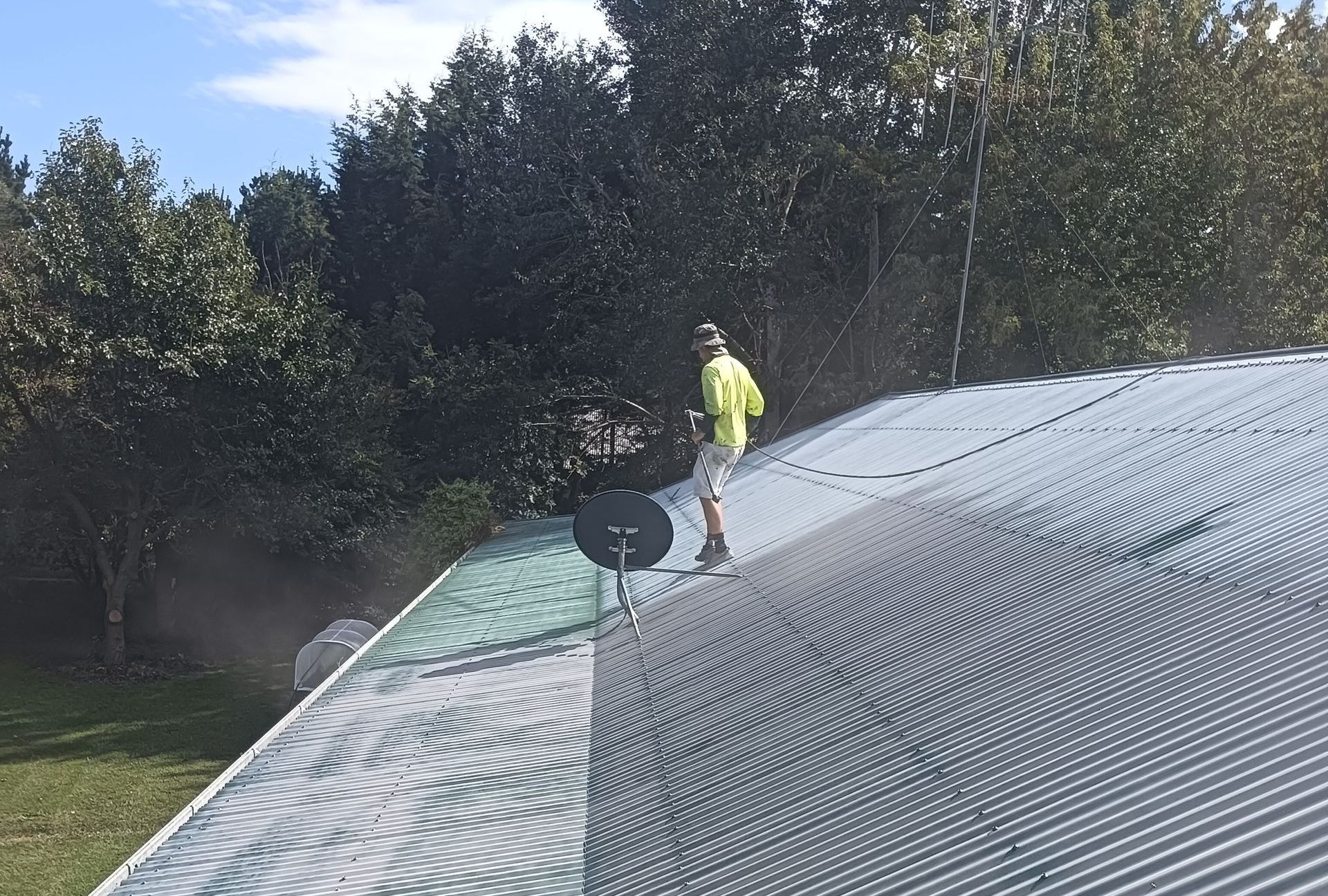 A Person is Painting a Roof — A-Z Property Painting In Karuah, NSW