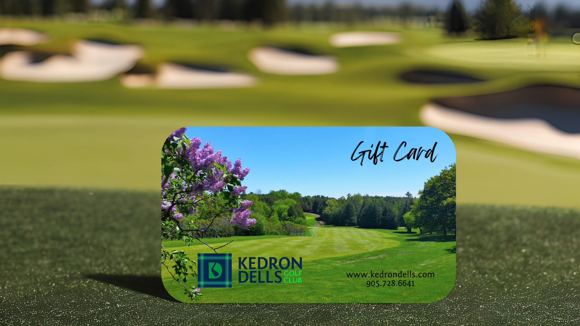 A gift card for kedron dells is sitting on a golf course