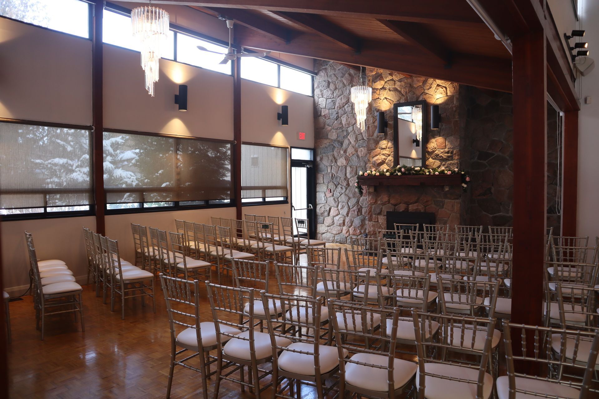 A large room with rows of chairs and a fireplace