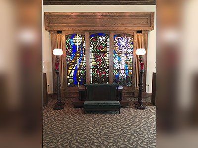 there is a stained glass window in the middle of the room.