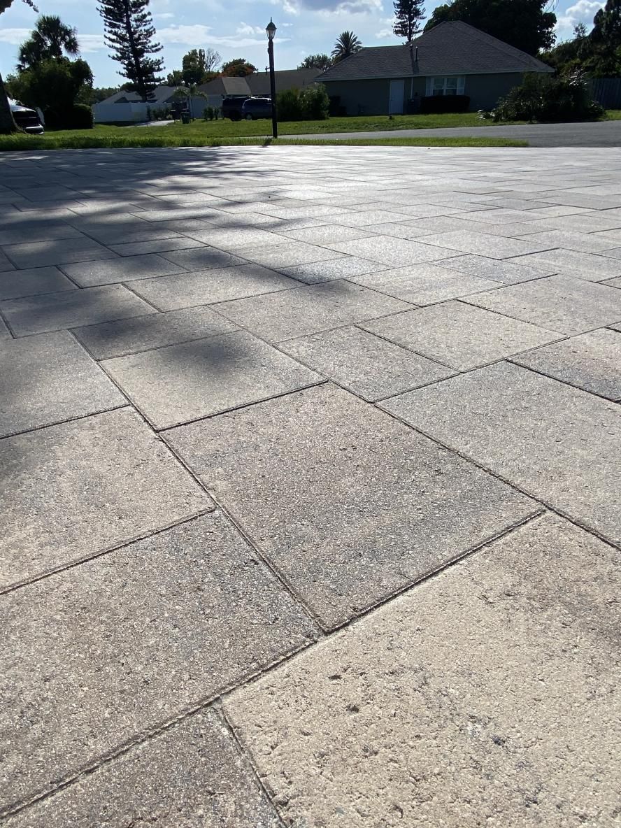 Close-up of stone pavers in a driveway, tan and gray tones. 