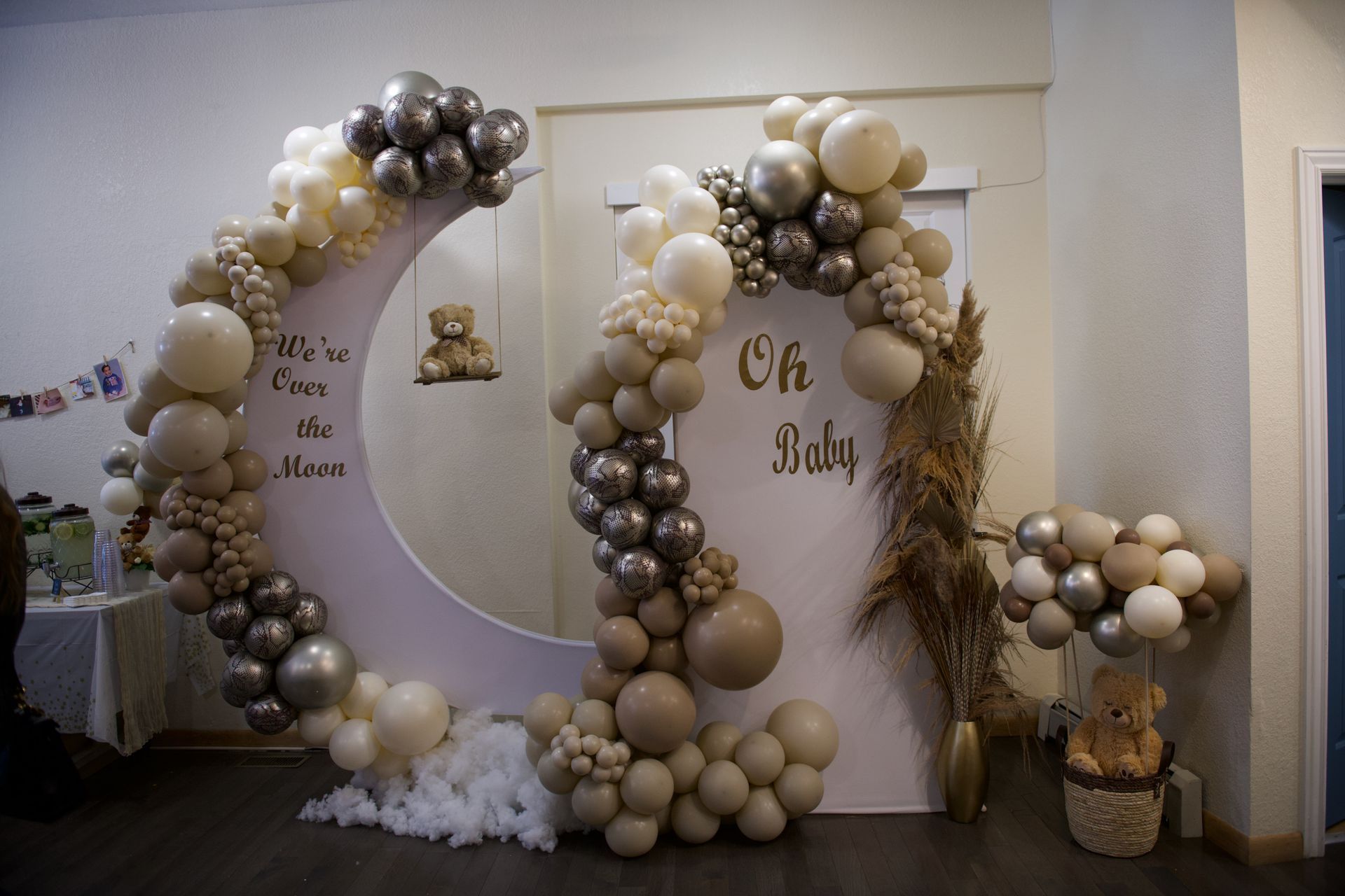 A room decorated with balloons and a crescent moon for a baby shower.