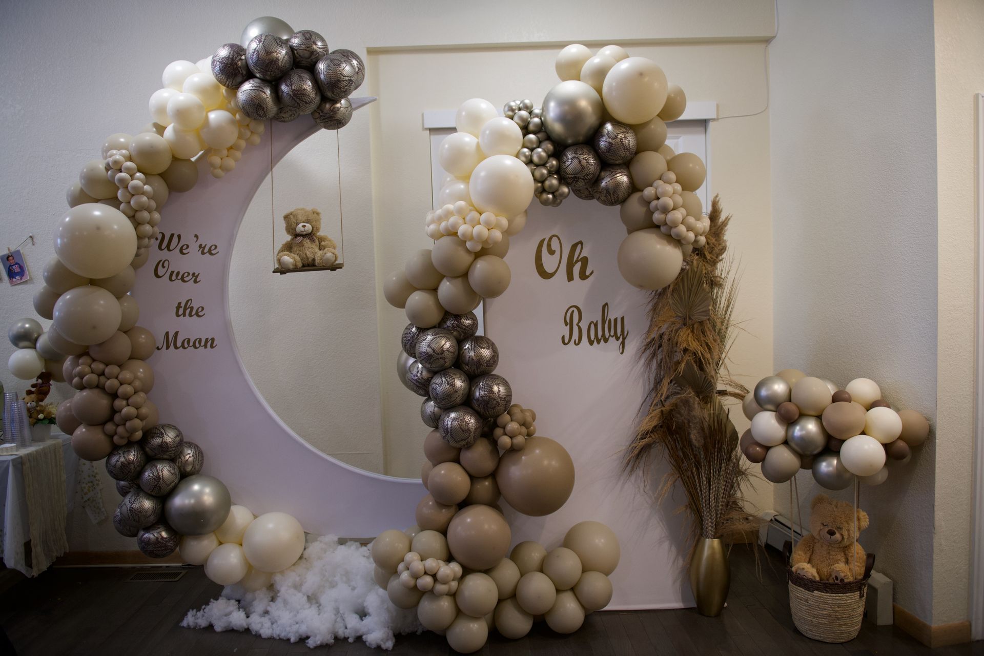 A room decorated with balloons and a crescent moon for a baby shower.