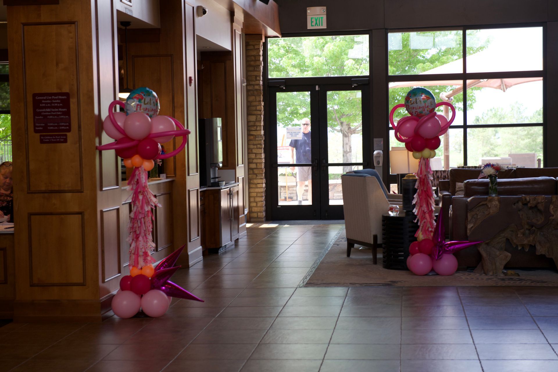 A hallway filled with balloons and decorations for a party.