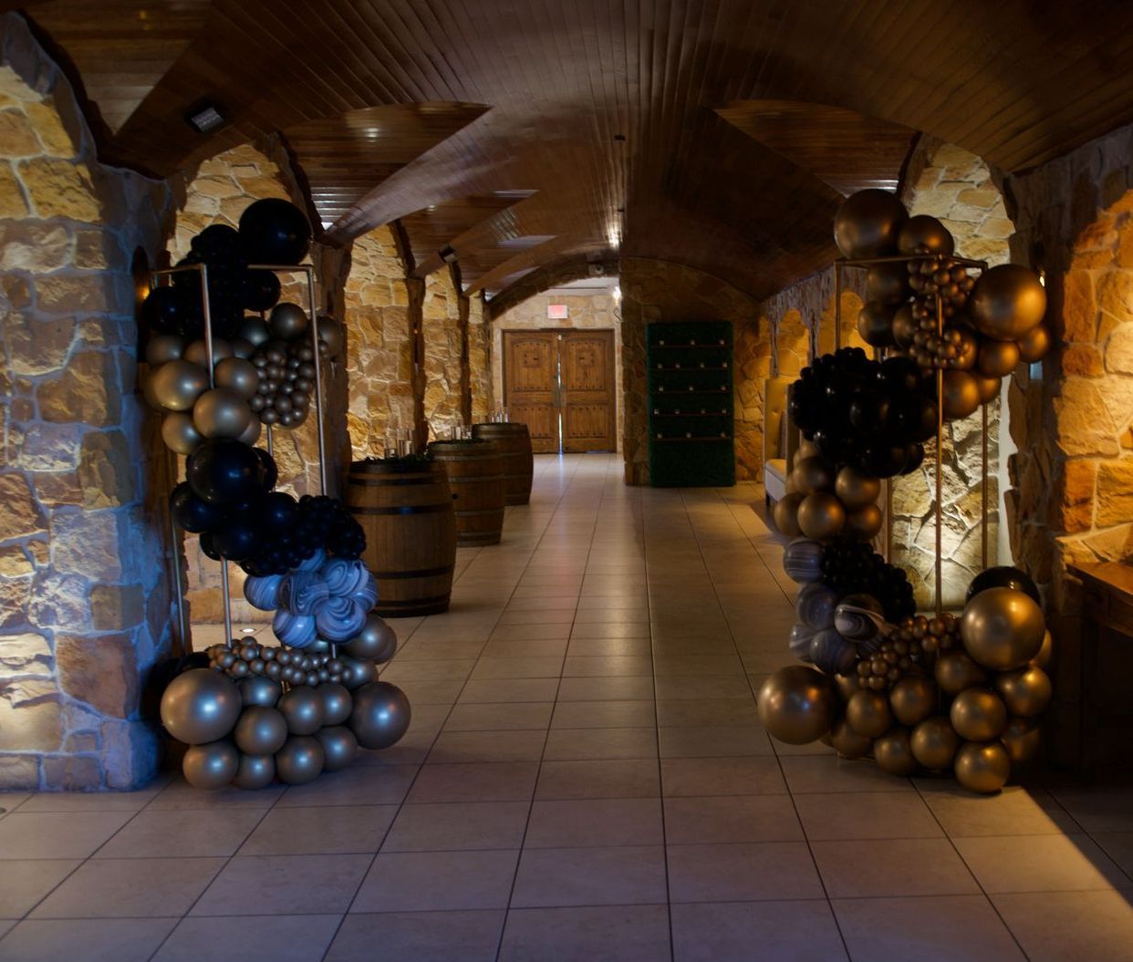 A hallway with a bunch of balloons hanging from the ceiling
