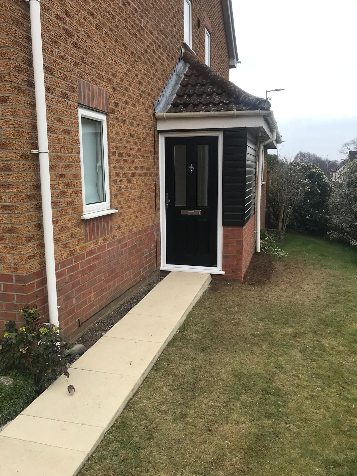 There is a ramp leading to the front door of a house.