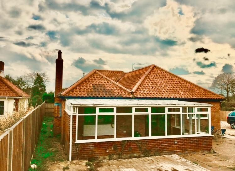 A brick house with a white awning on the side