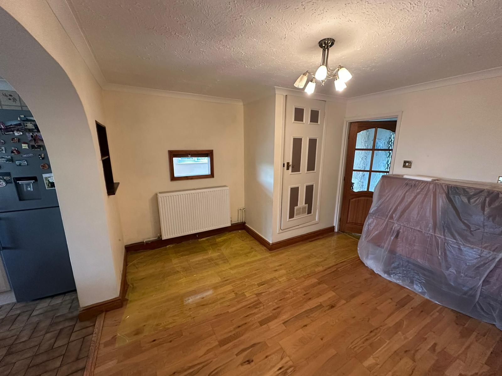 A pink house with a red tile roof and a white door