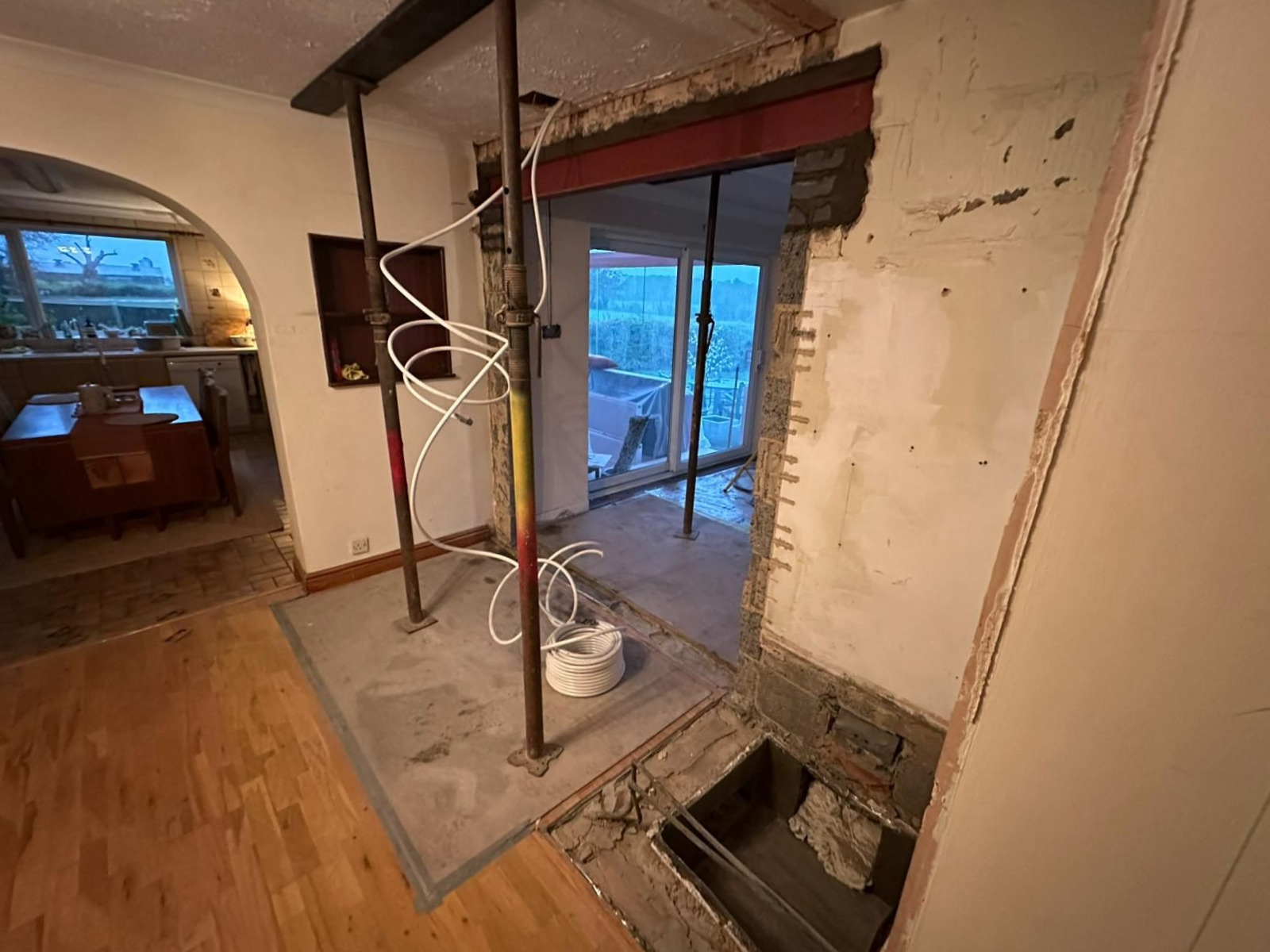 A large lush green field with a house in the background.