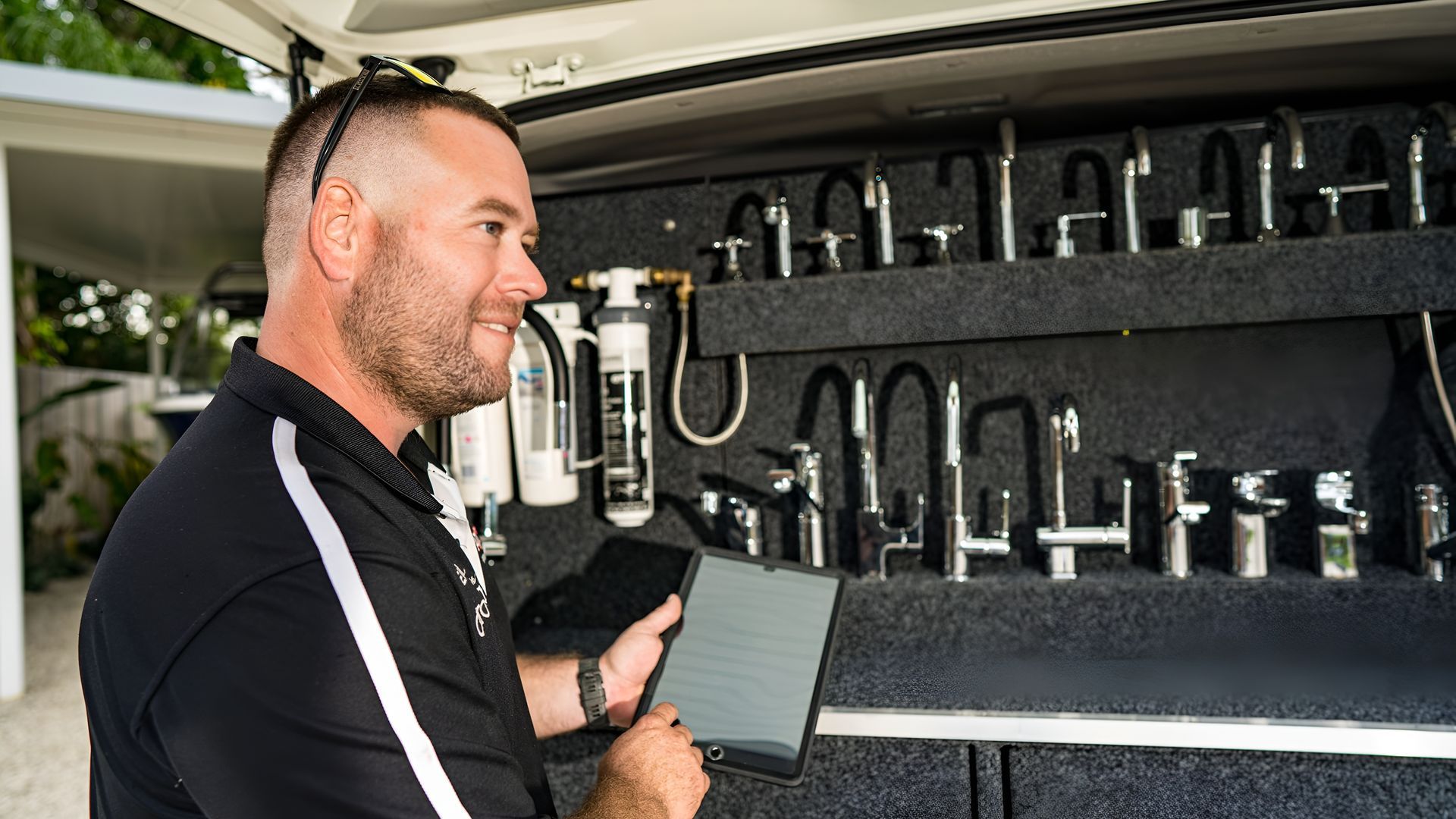A Man With Tablet Looks at Faucet Samples — Taps 'R' Us in Kunda Park, QLD