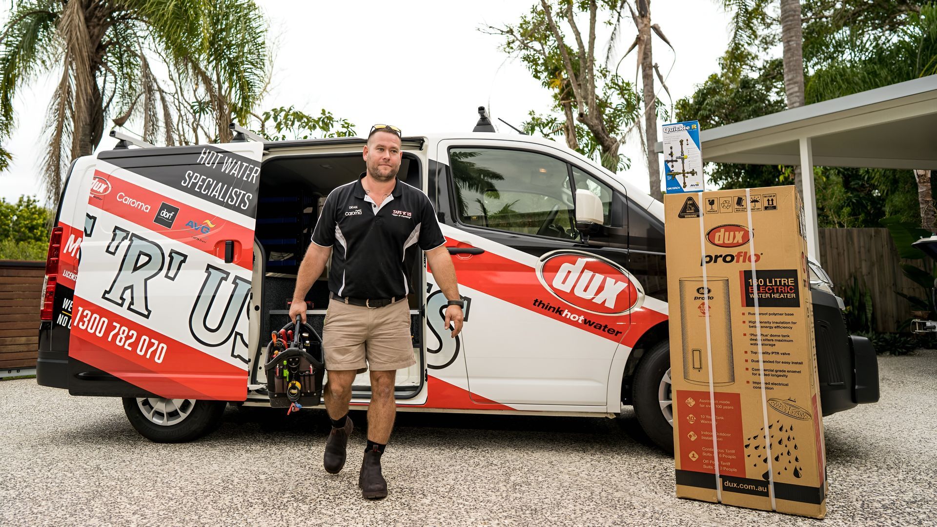 Man in Shorts and Work Attire, Exiting a Van With 'dux' Branding — Taps 'R' Us in Maroochydore, QLD