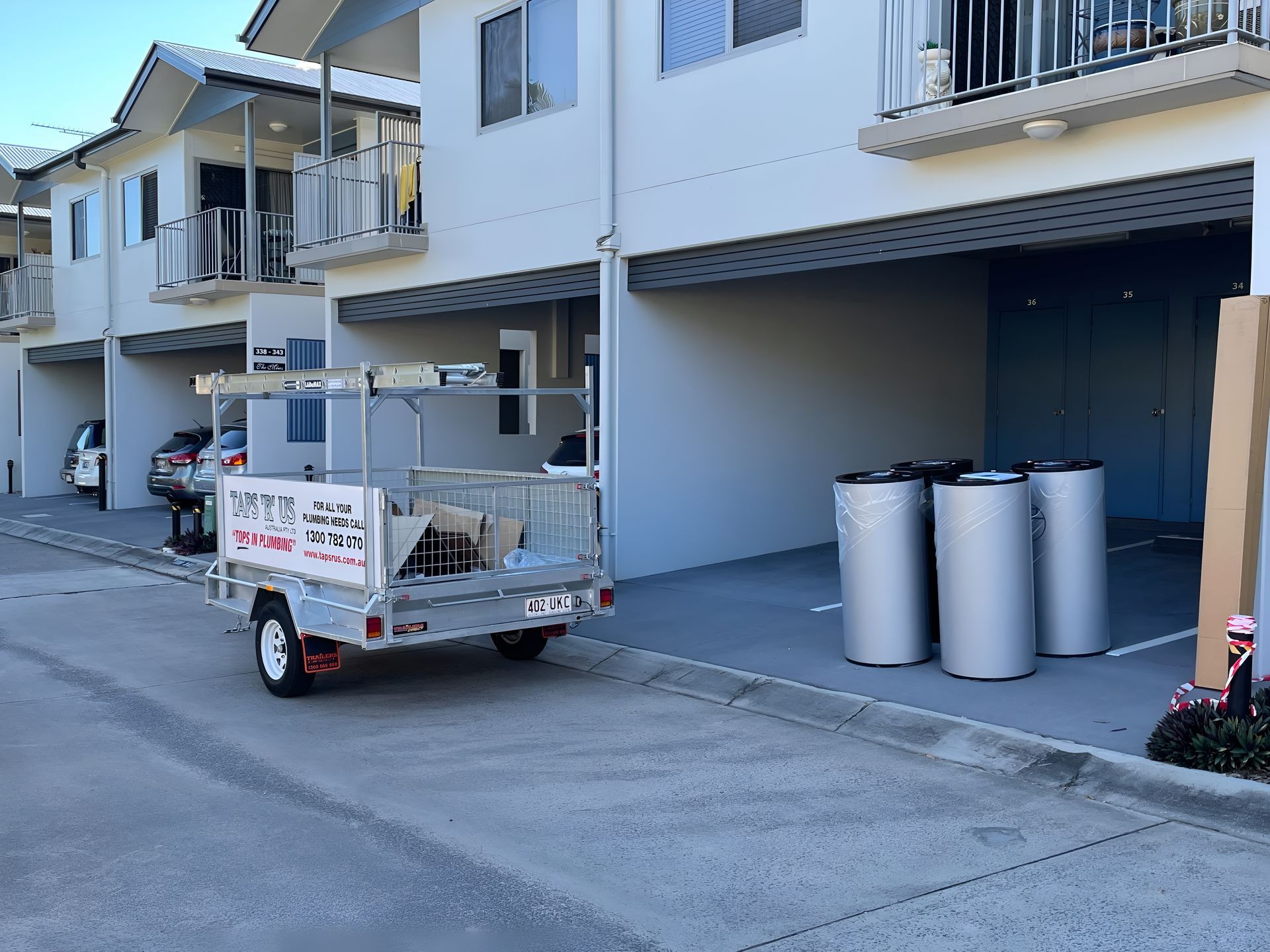 A trailer Loaded With Tools Parked Near a Building — Taps 'R' Us in Kunda Park, QLD