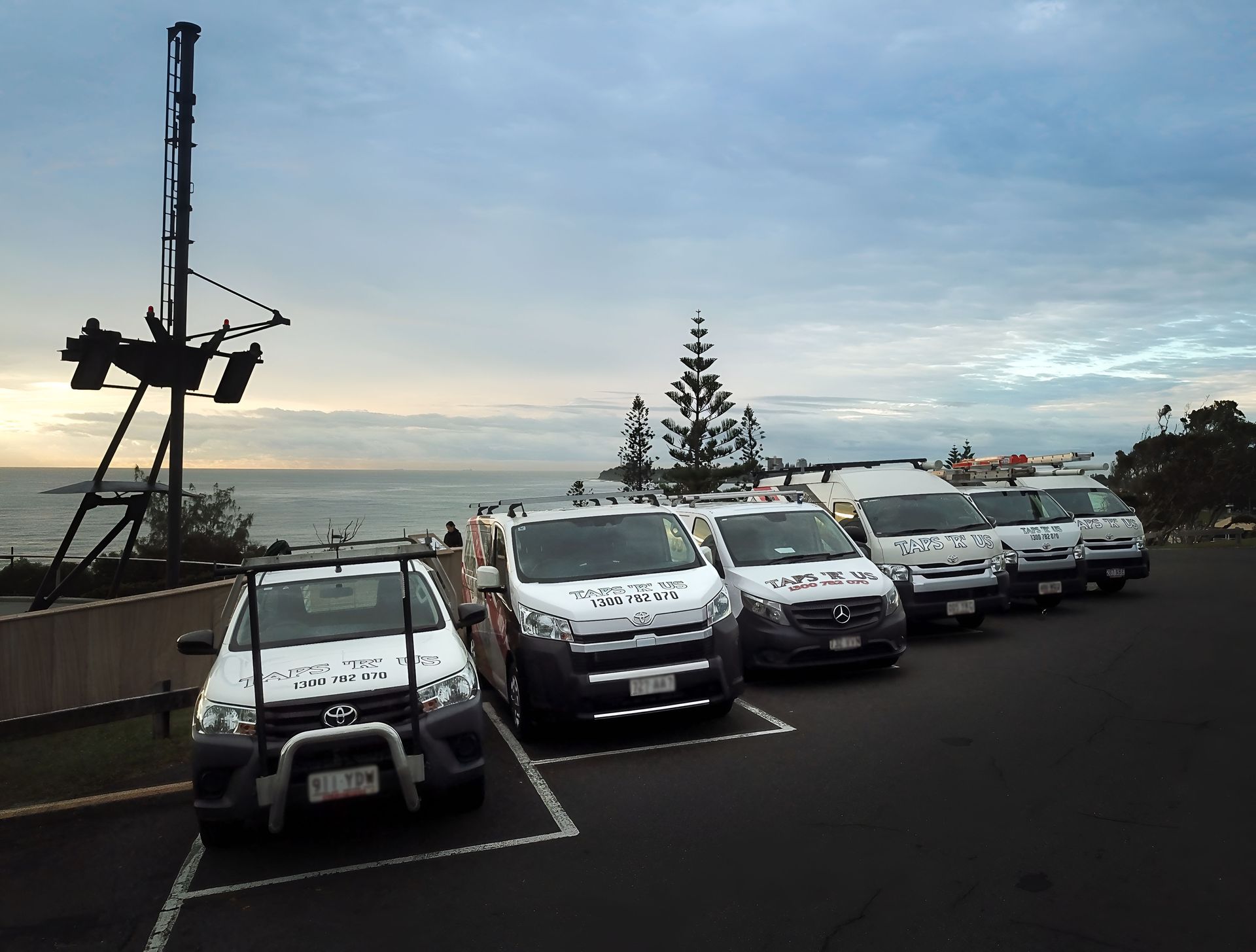 Five White Vans Parked Near the Ocean — Taps 'R' Us in Kunda Park, QLD