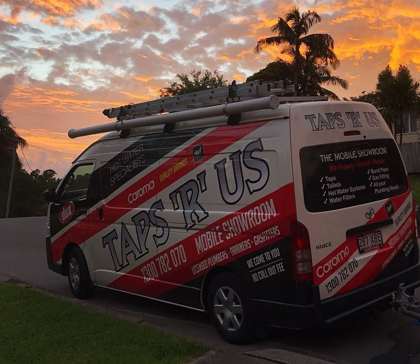 Man in White Shirt Repairing a White Toilet — Taps 'R' Us in Kunda Park, QLD
