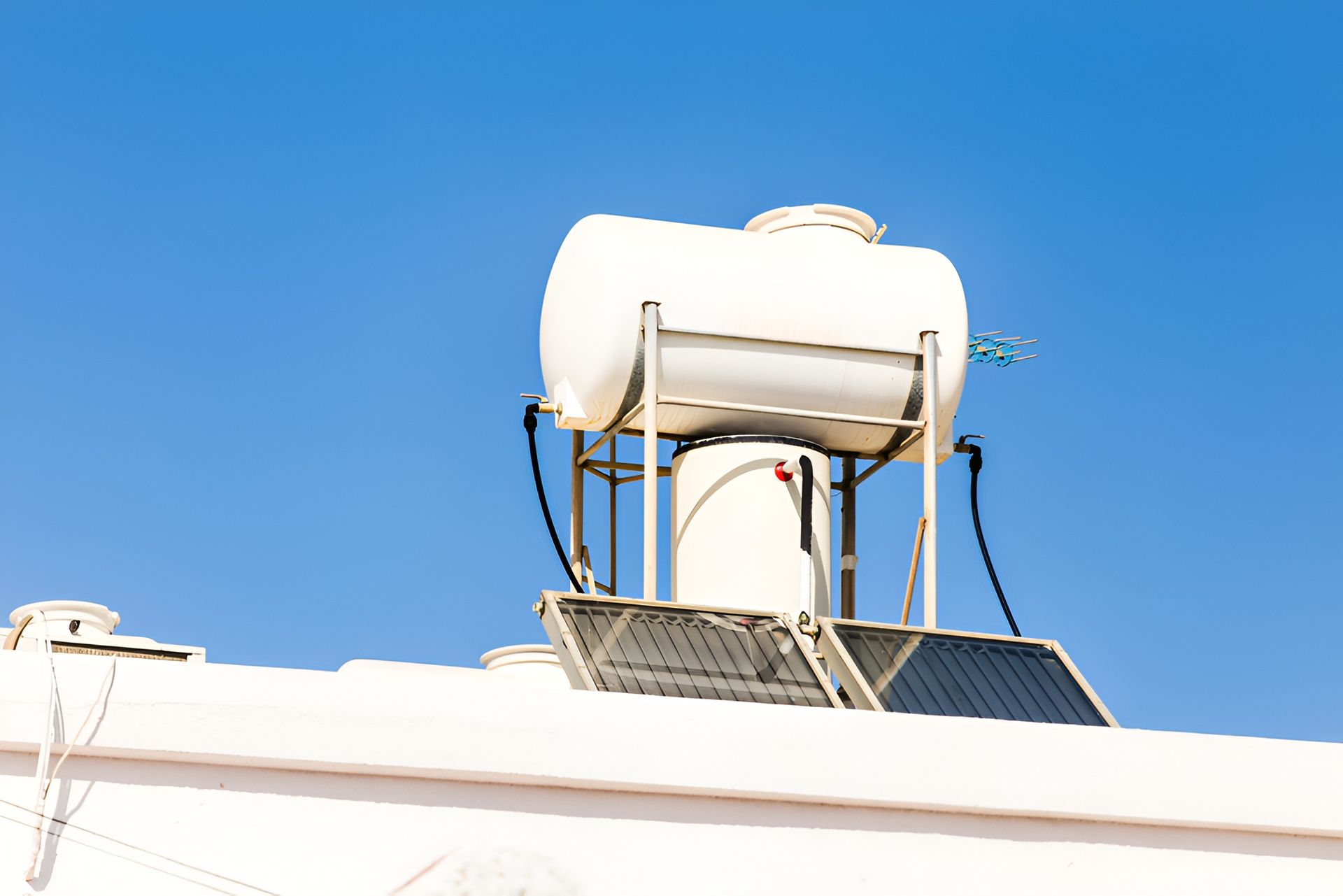 Solar Water Heater on a White Roof Against a Clear Blue Sky — Taps 'R' Us in Sippy Downs, QLD