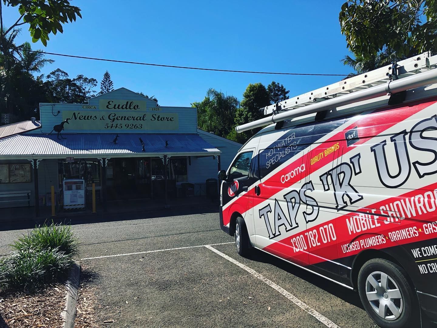 Van parked in front of a store. Bright blue sky — Taps 'R' Us in Caloundra, QLD